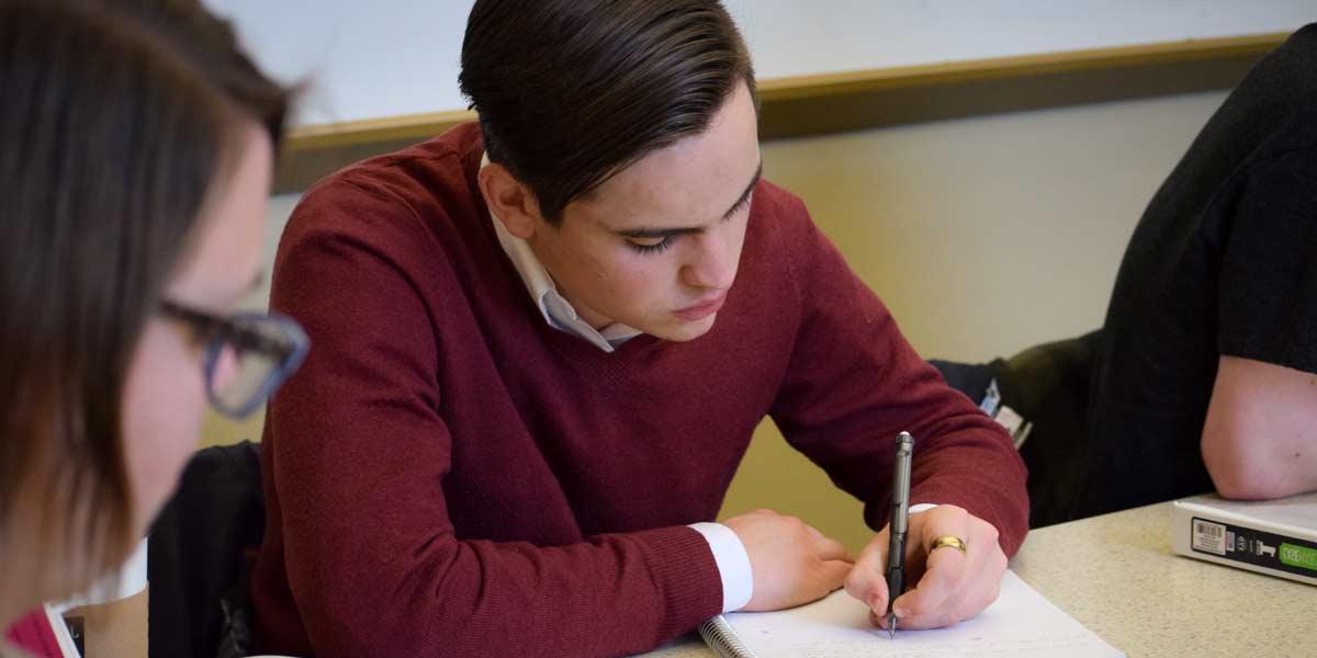 A student takes notes in a seminar class